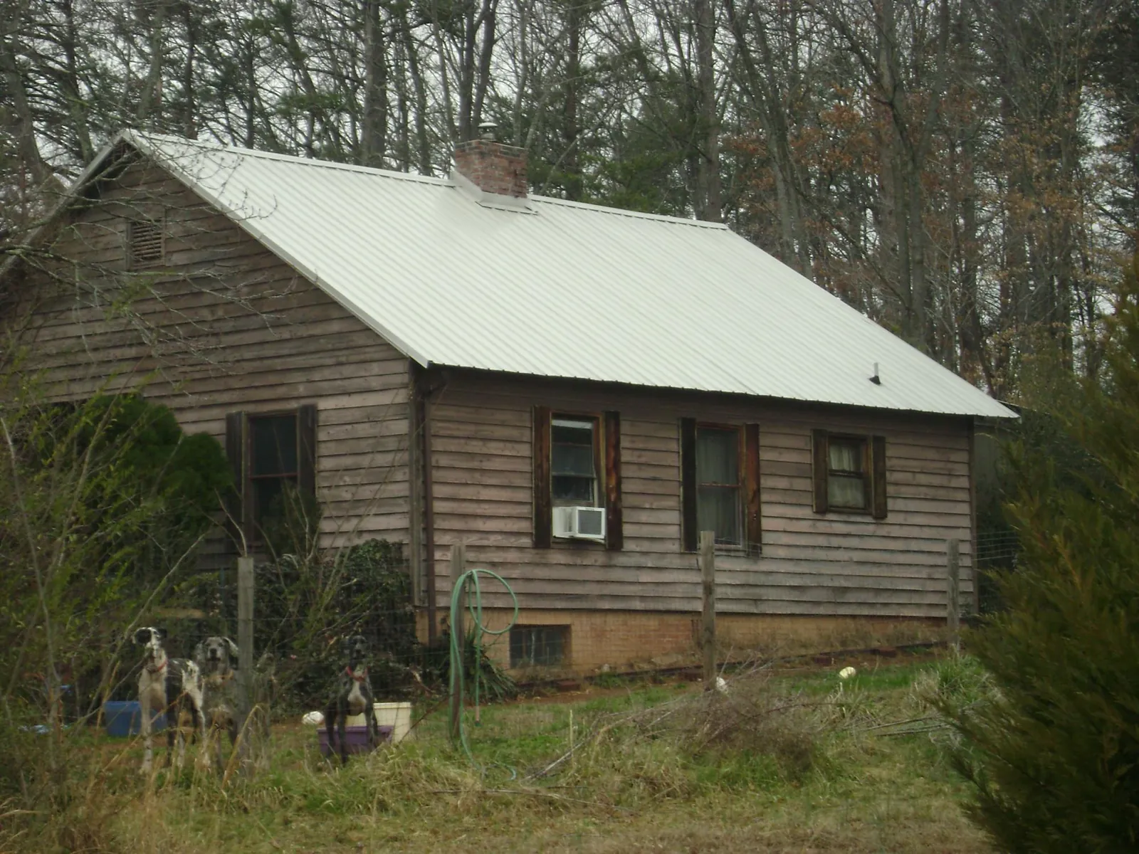 White metal roof on an old wood sided farmhouse, from a Metal Roof Installation job in Sparks
